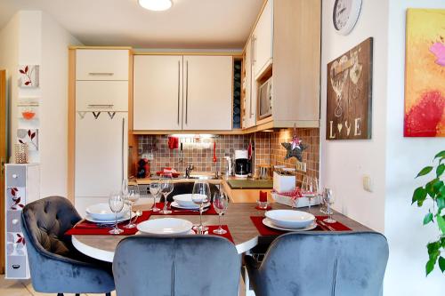 a kitchen with a wooden table with chairs and a dining room at Daheim in Koserow in Ostseebad Koserow