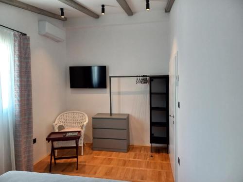 1 dormitorio con 1 cama y TV en la pared en Unique residence with garden and sea view en Split