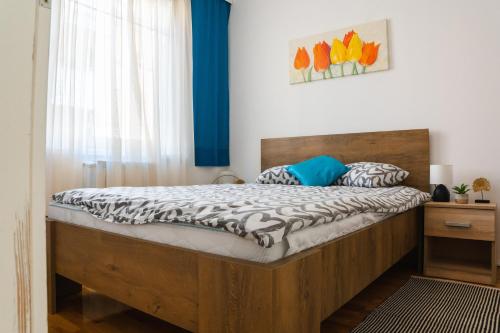 a bedroom with a large wooden bed in a room at Flexible SelfCheckIns 52 - Zagreb - Parking - Loggia in Zagreb