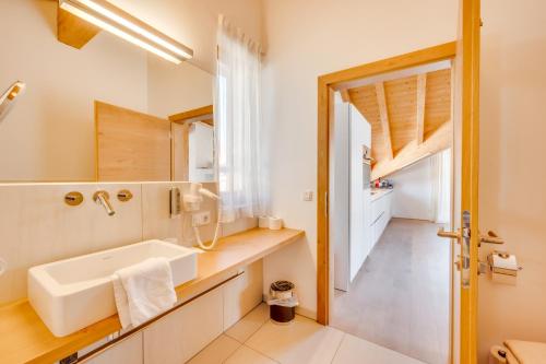 a bathroom with a sink and a mirror at Chalet Bergliebe zentral mit Bergblick in Seefeld in Tirol