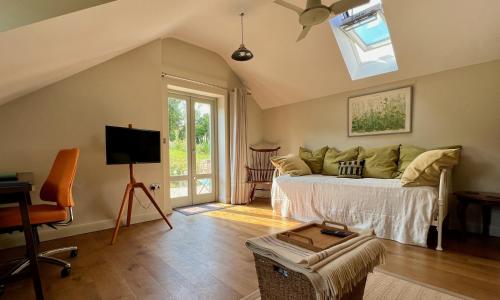 a living room with a bed and a skylight at Dyffryn in Newport Pembrokeshire
