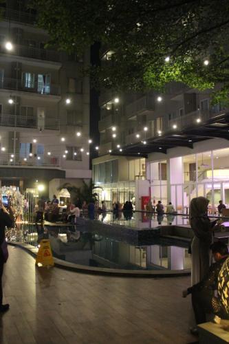 a group of people in a building at night at Apartement Bogor Icon Syariah, View Gunung Salak in Bogor