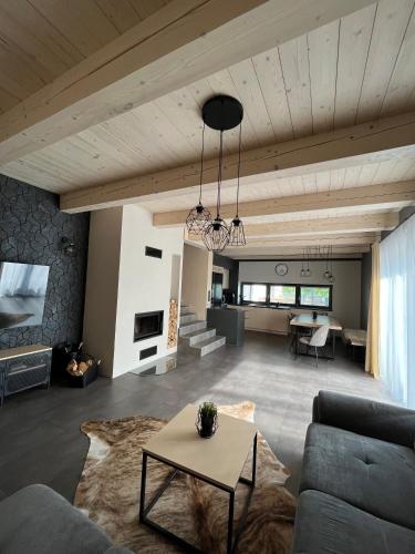 a living room with a couch and a table at CHALETY MÝTO POD ĎUMBIEROM in Mýto pod Ďumbierom