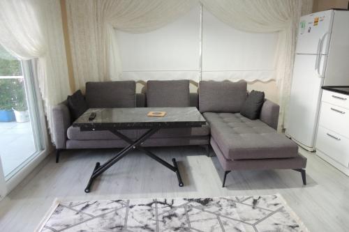 a living room with a couch and a table at Mavi Apart in Demre