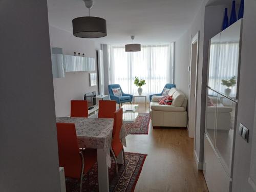 a dining room and living room with a table and chairs at APARTAMENTO AKATZ in Mundaka