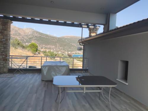 a room with a table and a view of a mountain at Paraiso Azul Villas in Áyios Dhimítrios