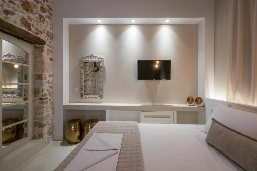 a bedroom with a bed and a tv on a wall at il Campanile Luxury Living in Chania Town
