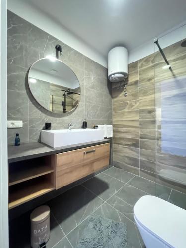 a bathroom with a sink and a mirror at Calypso in Trogir