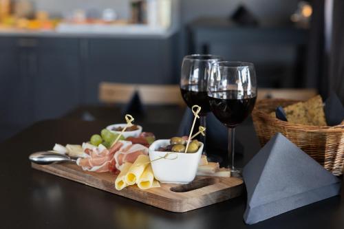 a table with a plate of food and a glass of wine at Hotell Leksand in Leksand