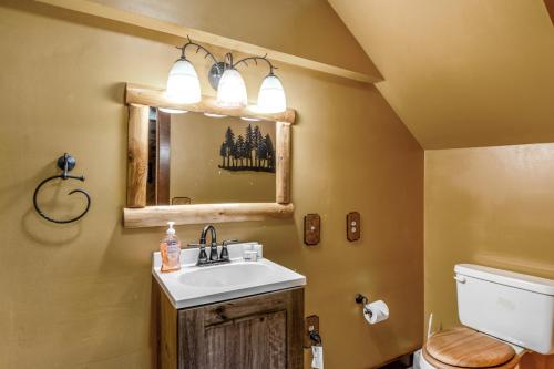 a bathroom with a sink and a toilet and a mirror at Loon's Landing in Mercer