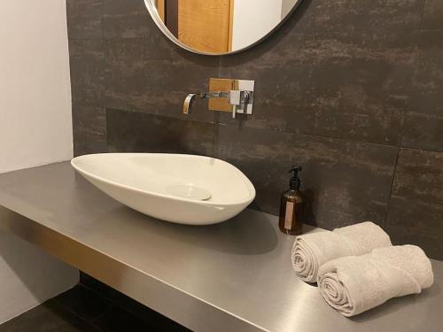 a bathroom with a white bowl sink on a counter at CASA Raiz in Ponta Delgada