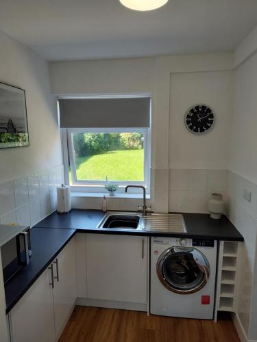 a kitchen with a sink and a washing machine at Jarvis Drive 3 Bed contractor house In melton Mowbray in Melton Mowbray
