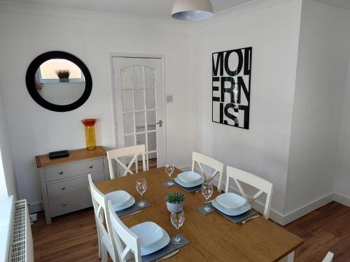 a dining room with a wooden table and chairs at Jarvis Drive 3 Bed contractor house In melton Mowbray in Melton Mowbray