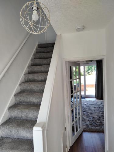 a staircase in a home with a white stair case at Jarvis Drive 3 Bed contractor house In melton Mowbray in Melton Mowbray