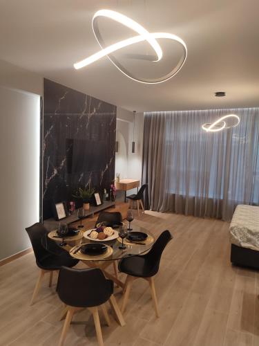 a living room with a table and black chairs at Amazing Apartments @ Monastiraki Subway Station in Athens