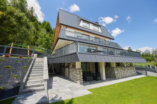 a house with a balcony on top of a building at EveRest Apartamenty Szczyrk in Szczyrk