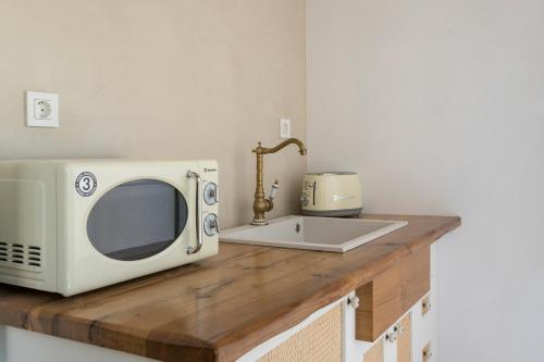 a microwave on a wooden counter with a sink at il Campanile Luxury Living in Chania Town