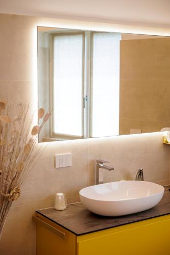 a bathroom with a sink and a mirror at REVO Apartaments - Gualzi63 the Best View in Sondrio