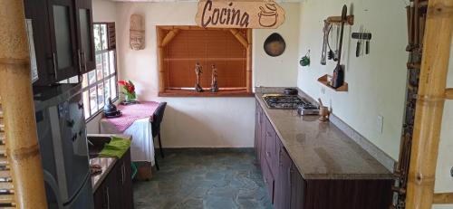 a kitchen with a sink and a counter top at Cabaña Mikhuna, Bienestar en las montañas !!! in Anolaima