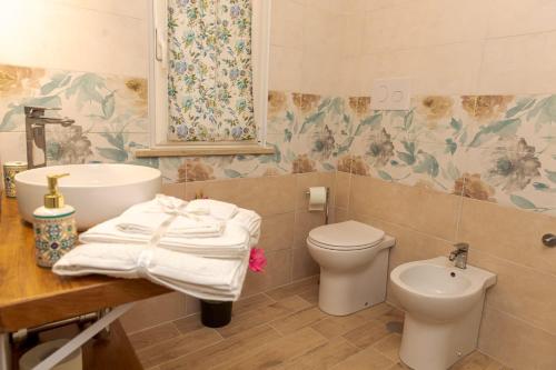 a bathroom with a sink and a toilet at Sea Garden Apartments in Ascea