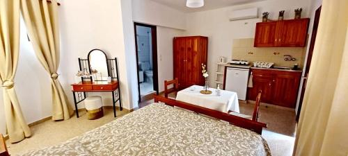 a bedroom with a bed and a kitchen with a sink at Pefkos Filoxenia in Pefki Rhodes