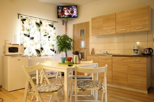 a kitchen with a table and chairs and a tv at Ubytování v soukromí U Volného in Příbor