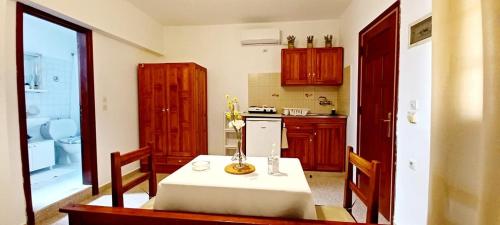 a kitchen with a table and a sink and a stove at Pefkos Filoxenia in Pefki Rhodes