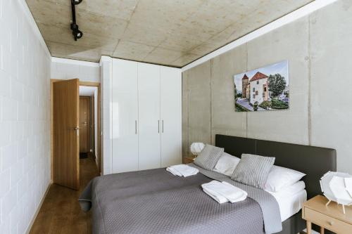 a bedroom with a bed with two towels on it at River Side Residence nr3 in Oświęcim