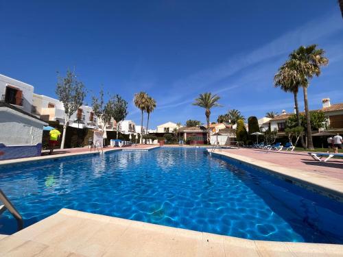 una gran piscina azul con palmeras y casas en VERA SUN LUXURY new!!! 137 en Vera Coast, en Vera