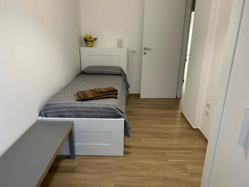a small bedroom with a bed in a room at Central Modern Apartment Bari in Bari