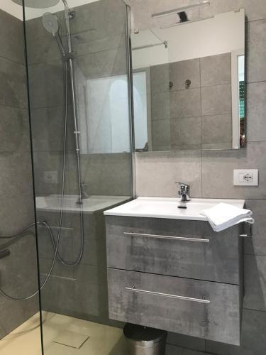 a bathroom with a sink and a shower at Hotel Bersagliere in Laglio