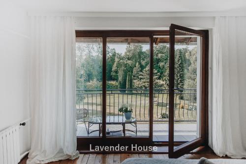 a room with a large glass door to a balcony at Lavender House in Osieki