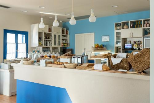 a bakery with a counter with baskets on it at Anemomilos in Oia