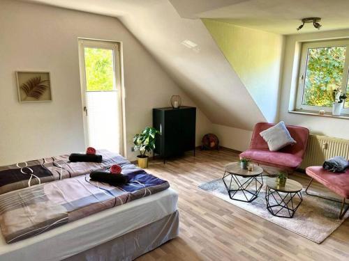 a room with a bed and a couch and a chair at Zuhause im Ruhrgebiet 2 mit Balkon in Oberhausen