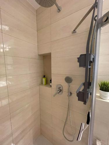 a bathroom with a shower with a glass door at Apartament Jaśminowa in Chrzanów