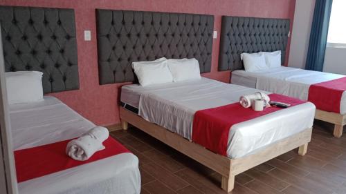 Giường trong phòng chung tại Hotel La Intimidad