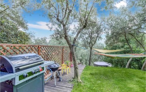 a grill on a deck next to a tree at 3 Bedroom Gorgeous Home In Uscio in Uscio