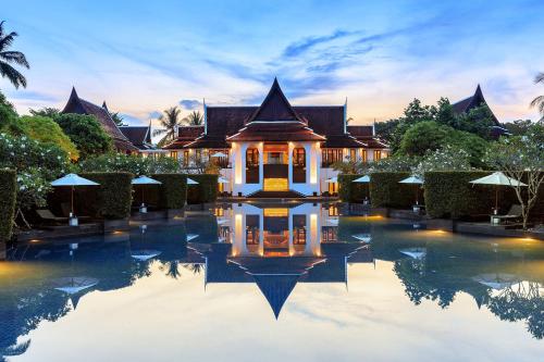 a villa with a pool in front of a house at JW Marriott Khao Lak Resort Suites in Khao Lak