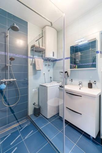 a bathroom with a shower and a toilet and a sink at Anda - Kuća za odmor in Milna