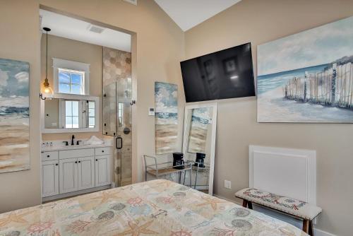 a bathroom with a bed and a sink and a mirror at Quiet coastal home w gorgeous patio, steps from beach in Port Aransas