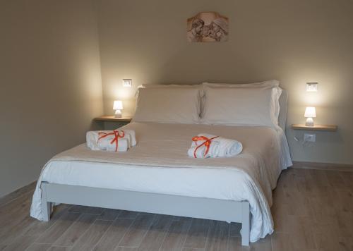 a white bed with two towels on top of it at Casa Sautu-fau in Santa Venerina