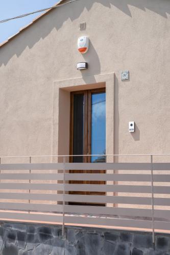 a house with a fence and a window at Casa Sautu-fau in Santa Venerina