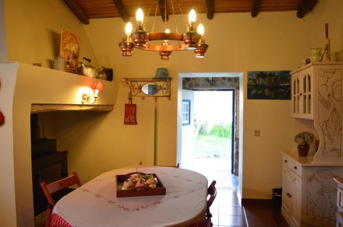 a kitchen with a table with a bowl of fruit on it at Monte do Rei Santo in Arronches