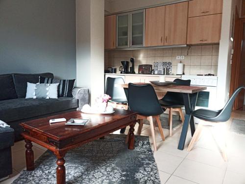 a living room with a couch and a table and chairs at Vaikouzis Houses in Samothráki