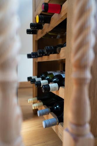 a bottle of wine in a wooden wine cellar at Silverwood Loft in Telford