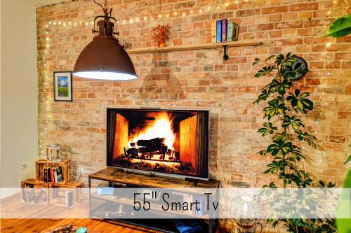 a brick wall with a fireplace in a living room at Uhlpartment - Romantisches Apartment im Zentrum in Uelzen