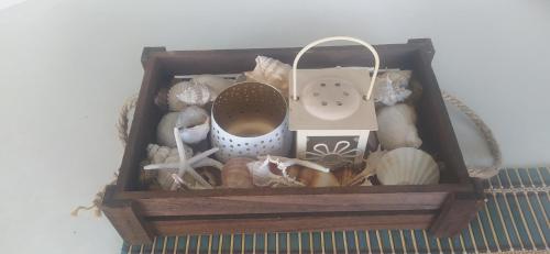 a wooden box filled with shells and a device at Madeline house in Kavala