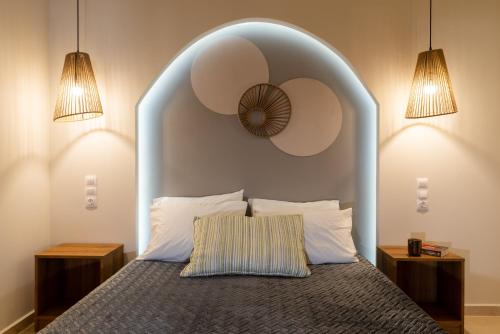 a bedroom with a large bed with a large headboard at Buganvilla-Sea front villas in Agia Pelagia