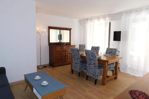 a living room with a dining room table and chairs at Cosy air-conditioned T2 "New California" with parking in Antibes