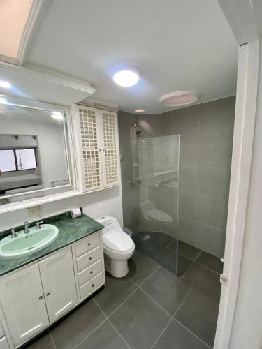a bathroom with a toilet and a sink and a shower at San Laurent in Cali
